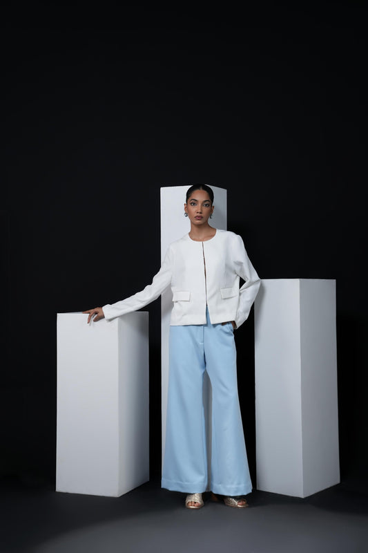 White jacket with sky blue trousers and swaroski detailing on the pockets