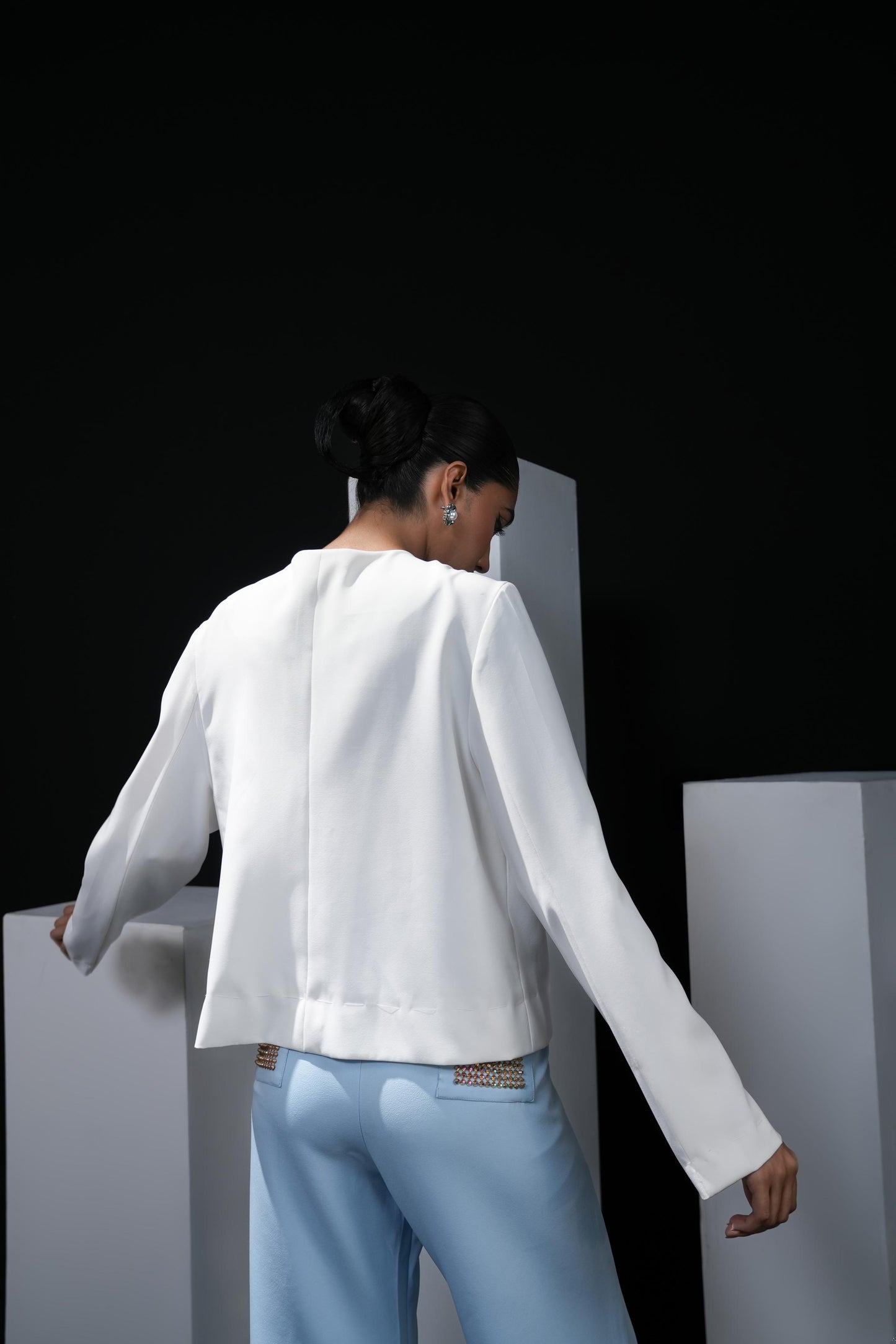 White jacket with sky blue trousers and swaroski detailing on the pockets