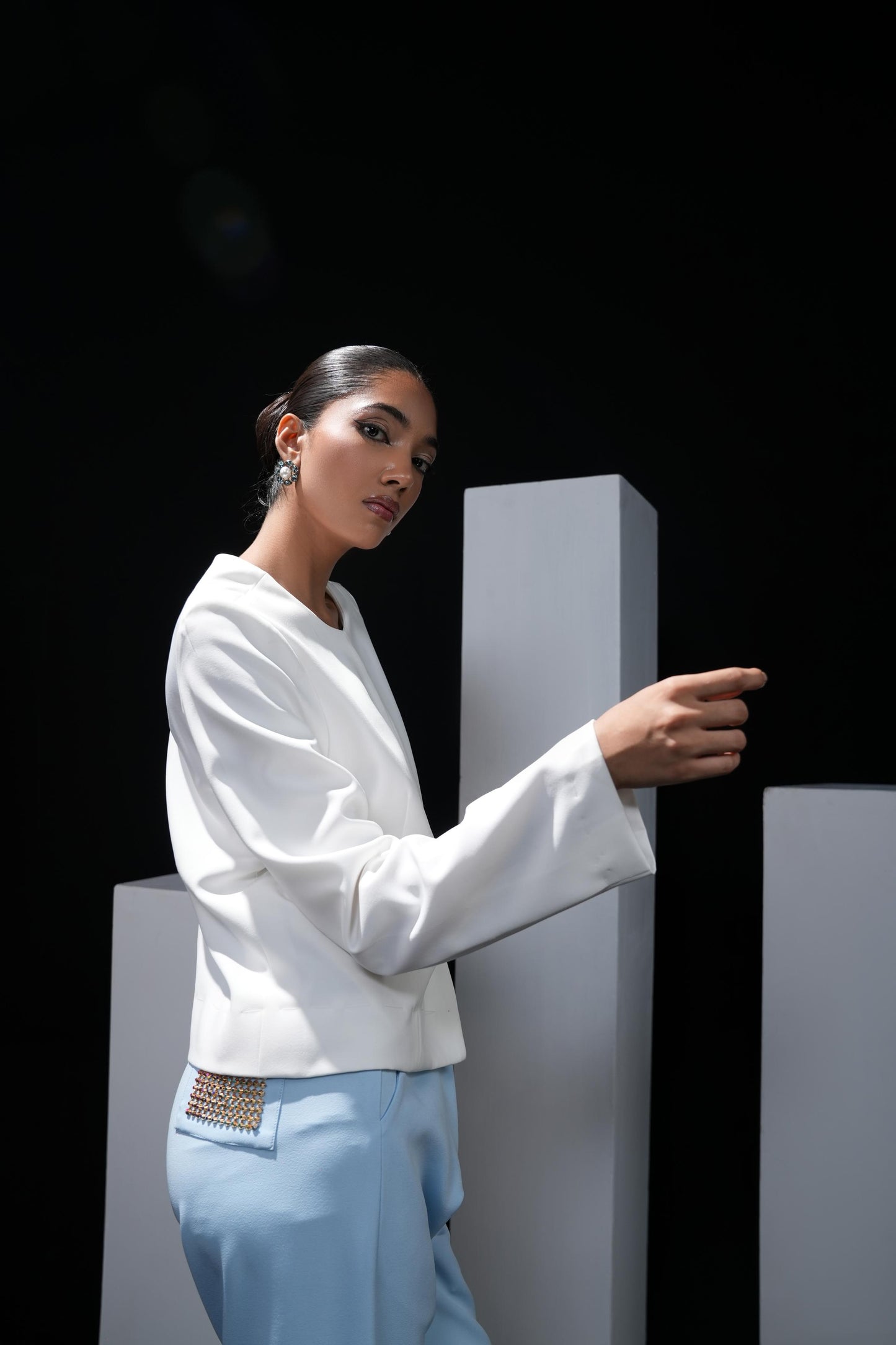 White jacket with sky blue trousers and swaroski detailing on the pockets