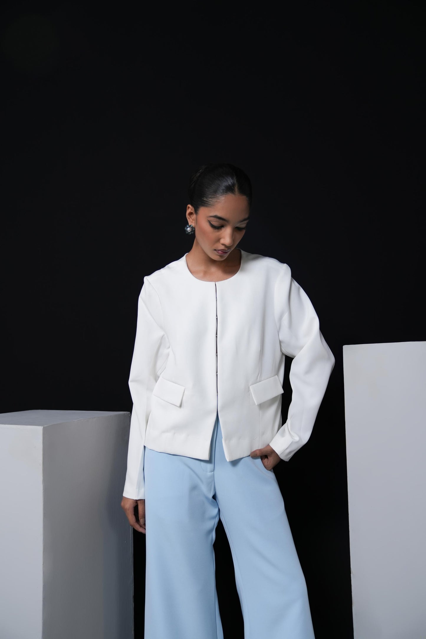 White jacket with sky blue trousers and swaroski detailing on the pockets