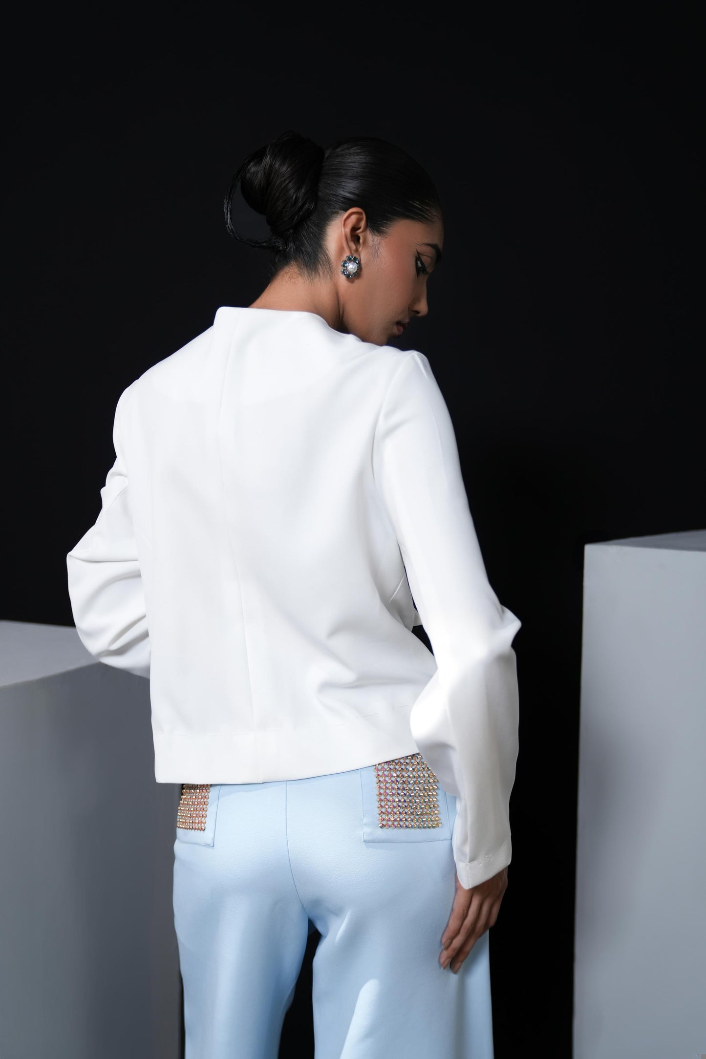 White jacket with sky blue trousers and swaroski detailing on the pockets