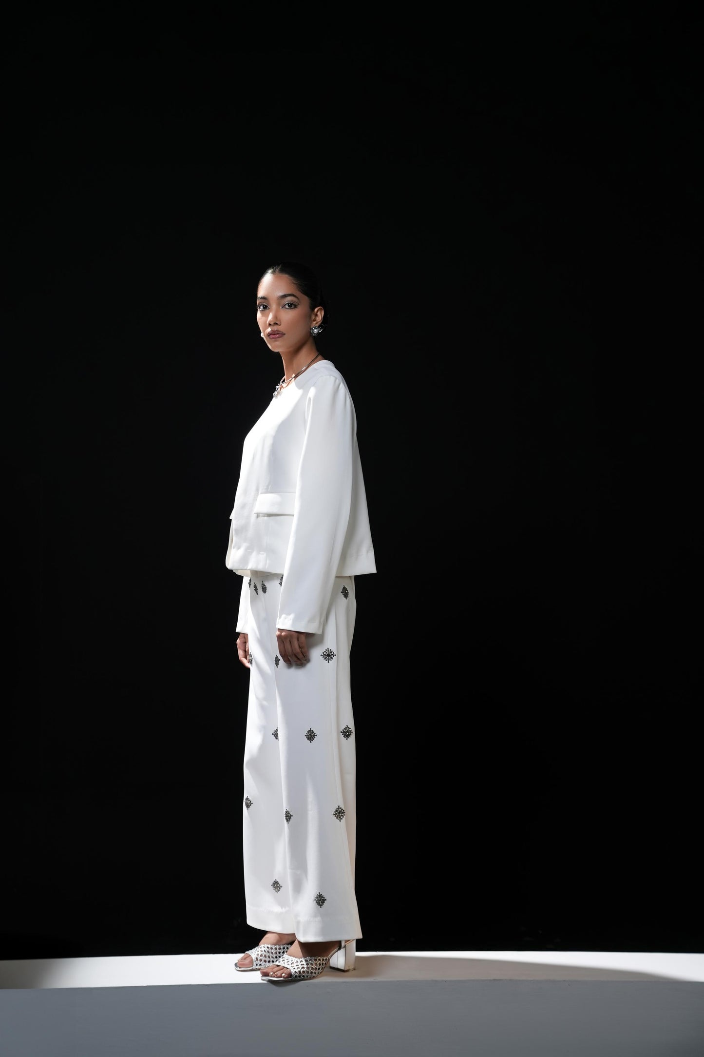 White bootcut trousers with swaroski embelishments