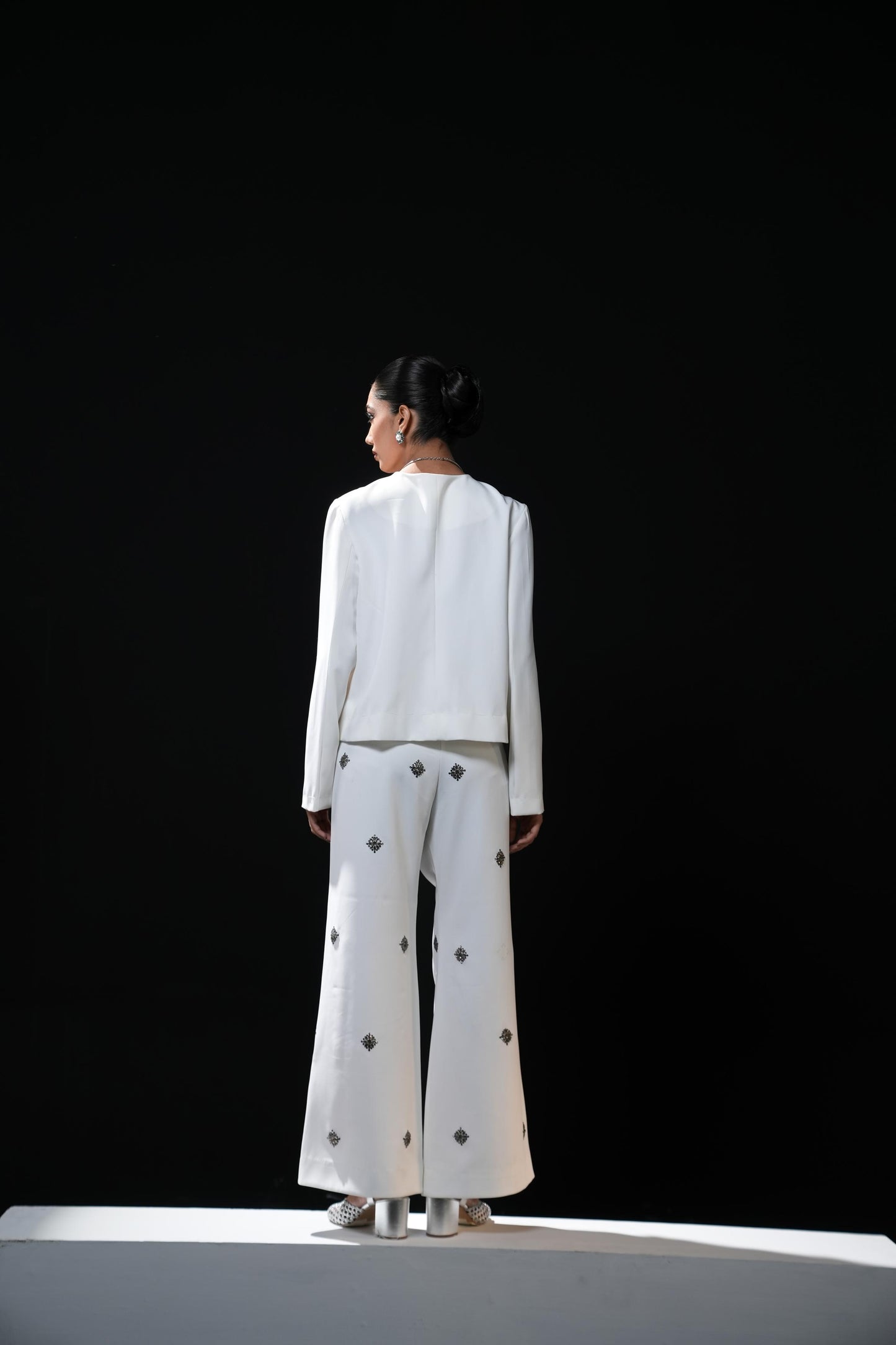 White bootcut trousers with swaroski embelishments