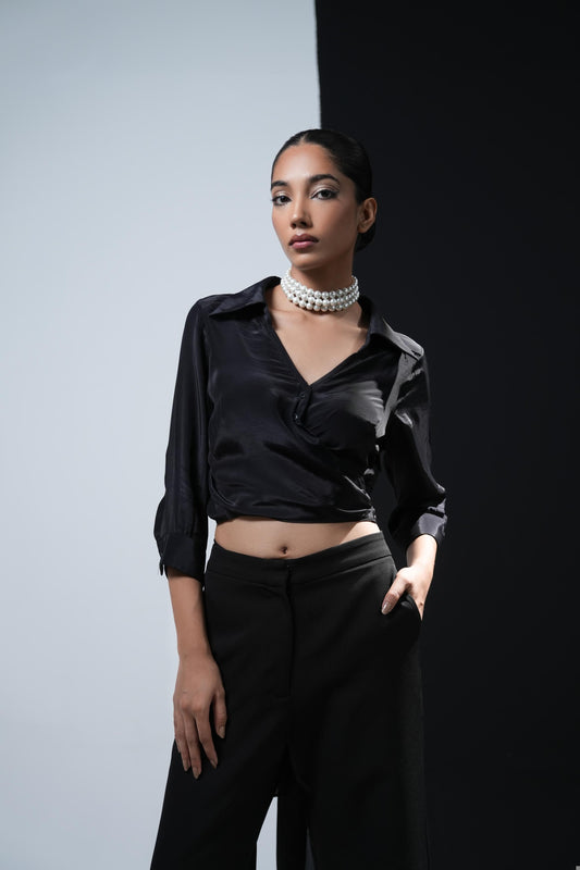 Black crepe overlapping shirt with a long bow paired with black trousers with swaroski pockets